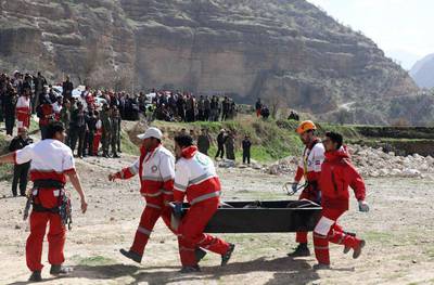 Members of the Iranian Red Crescent carry a body recovered from a wreckage of the private jet which crashed in the mountains around the city of Shahr-e Kord. Alireza Motamedi / EPA