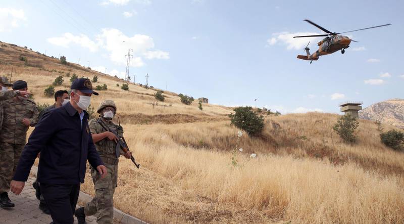 Turkish defence minister Hulusi Akar visits troops at the border with Iraq, in Hakkari province, Turkey. AP