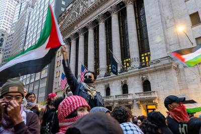 Supporters of Palestine hold a rally in New York's financial district to demand that American financial institutions stop financing weapons manufacturing. AFP