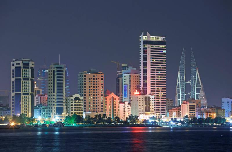 Cityscape of the hotels, skyscrapers and development along the 'Al Corniche' and the 'Diplomatic Area' of Manama in Bahrain illuminated at night.