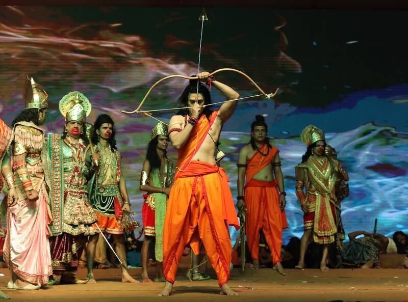 An artist dressed as Hindu deity Ram performs the 'Ramlila' along with other actors. EPA