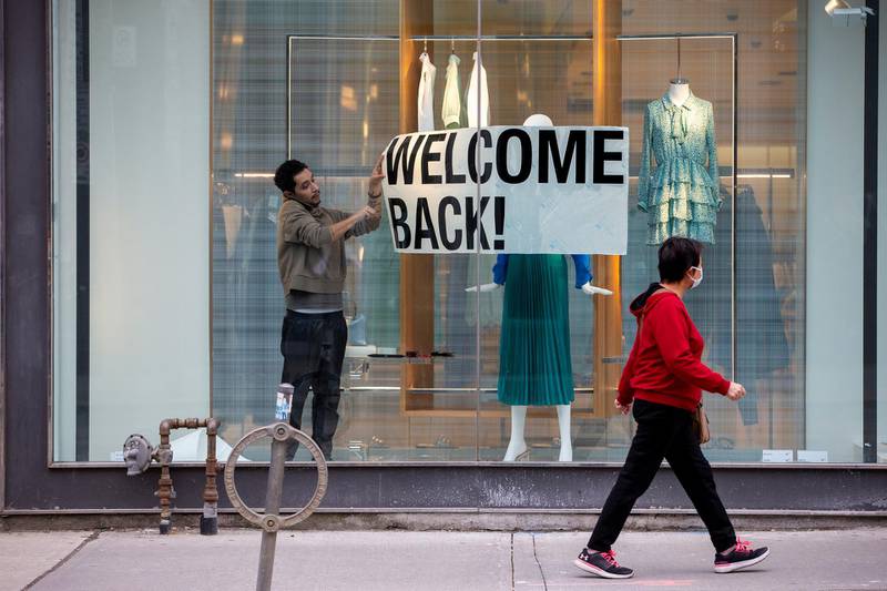 An employee at Zara puts up a sign during a phased reopening in Toronto, Ontario, Canada May 19. Carlos Osorio / Reuters