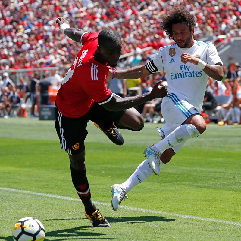 Real Madrid defender Marcelo, right, and Manchester United defender Eric Bailly in action. John G Mabanglo / EPA