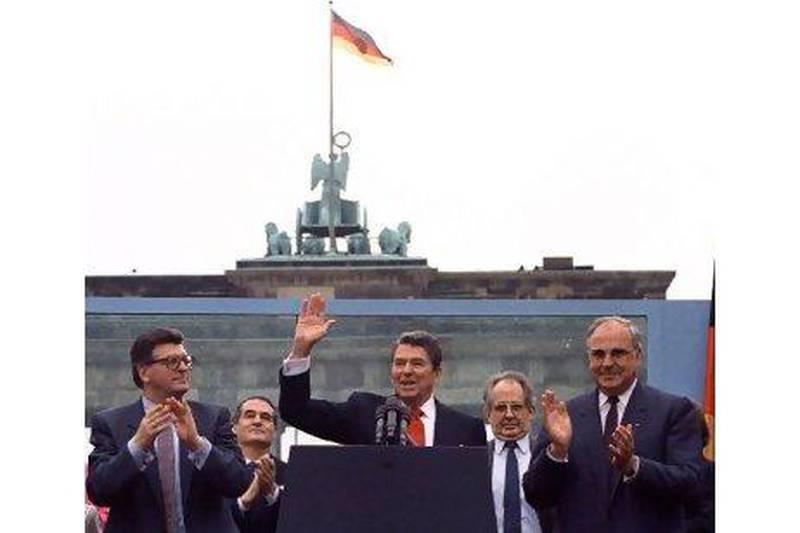 Reagan waves to the crowd after a speech in front of the Brandenburg Gate in West Berlin on June 12, 1987, during which he urged the Soviet president to 'tear down this wall'.