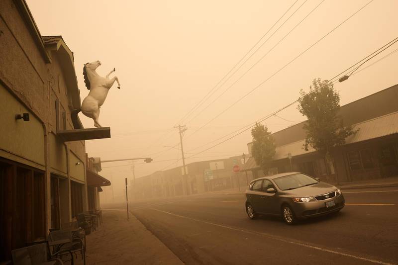 A car drives through the town of Molalla in Oregon, where about 10,000 residents were evacuated. Reuters