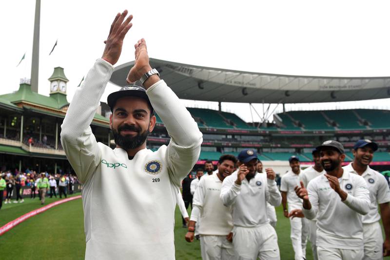 India's captain Virat Kohli gestures to supporters as his teammates celebrate a 2-1 series victory over Australia following play being abandoned on day five in the fourth test match between Australia and India at the SCG in Sydney, Australia, January 7, 2019. AAP/Dan Himbrechts/via REUTERS  ATTENTION EDITORS - THIS IMAGE WAS PROVIDED BY A THIRD PARTY. NO RESALES. NO ARCHIVE. AUSTRALIA OUT. NEW ZEALAND OUT.