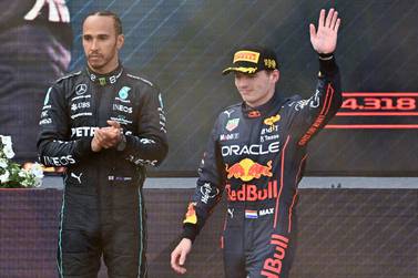 Second placed Red Bull Racing's Dutch driver Max Verstappen (R) walks past third placed Mercedes' British driver Lewis Hamilton on the podium after the Formula One Austrian Grand Prix at the Red Bull Ring race track in Spielberg, Austria, on July 10, 2022.  (Photo by Joe Klamar  /  AFP)