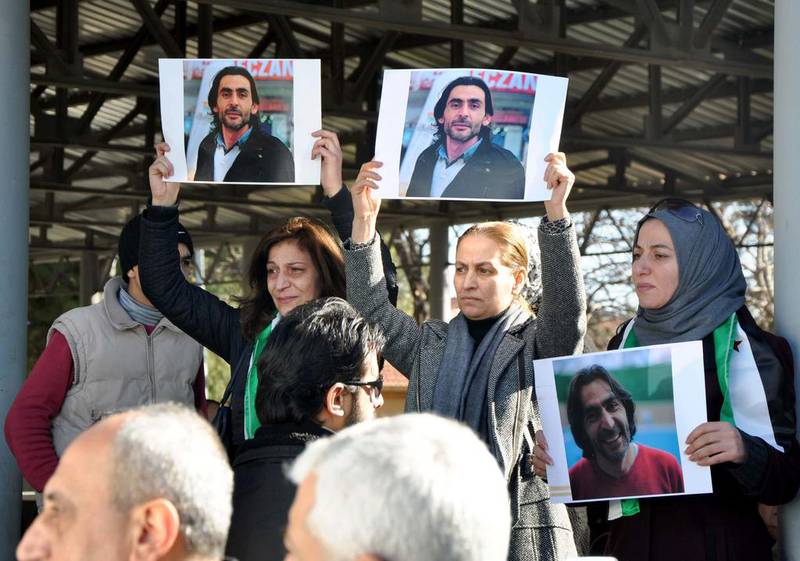 Women hold pictures of Naji Jerf, a Syrian journalist who was shot dead in Gaziantep, during his funeral in the southern Turkish city on December 28, 2015. AFP