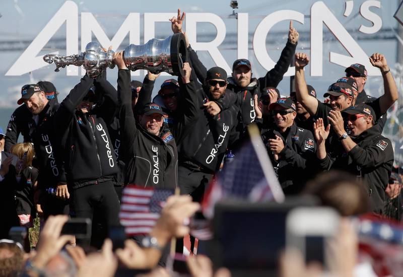 SAN FRANCISCO, CA - SEPTEMBER 25:  Oracle CEO Larry Ellison celebrates with the America's Cup trophy after Oracle Team USA beat Emirates Team New Zealand skippered by Dean Barker in race 19 to win the America's Cup Finals on September 25, 2013 in San Francisco, California.  (Photo by Ezra Shaw/Getty Images)