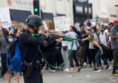 A police officer prepares to fire rubber bullets during a protest in Los Angeles. AP Photo