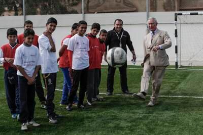 Prince Charles visits Jordanian children and Syrian refugees at a sports ground in Zaatari, Jordan, in 2015. Getty