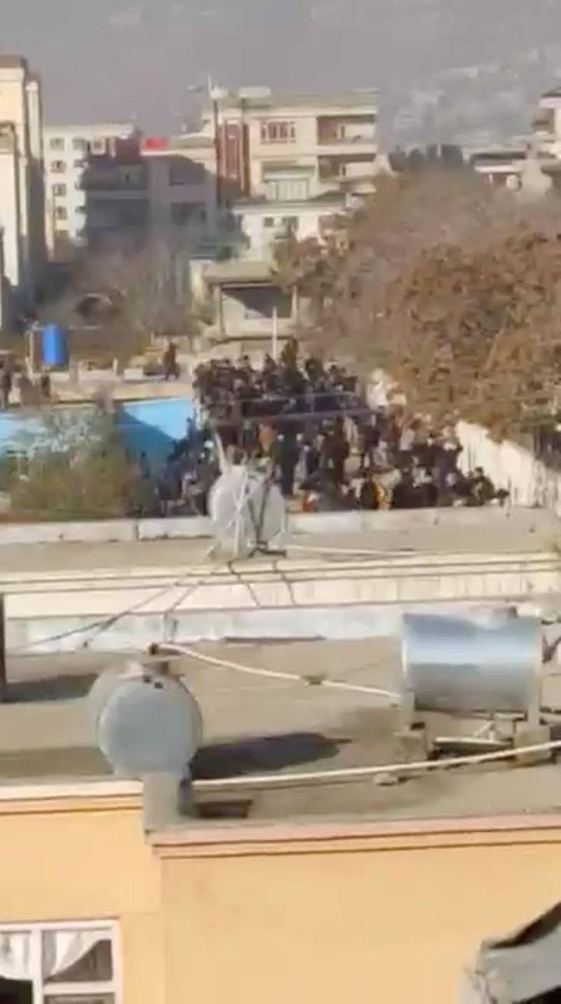People gather on a roof of a building in Kabul, Afghanistan in this still image obtained from a video.  REUTERS