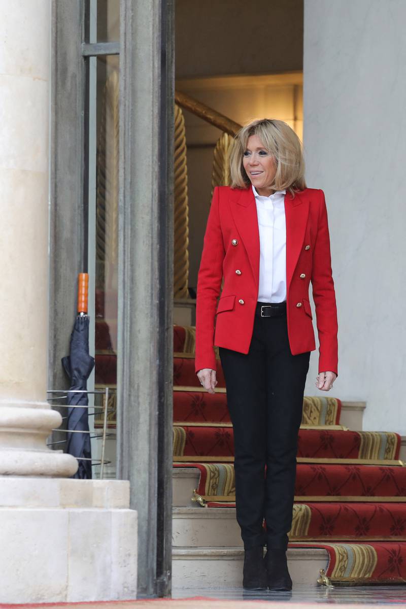 Brigitte, wearing a red blazer with black trousers, at the Elysee Palace on February 27, 2018. AFP