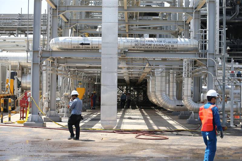 Workers are seen at the damaged site of Saudi Aramco oil facility in Khurais. Reuters