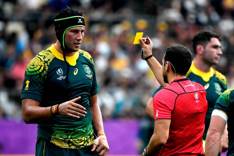 Match referee Mathieu Raynal, right, shows a yellow card to Australia's lock Adam Coleman. AFP