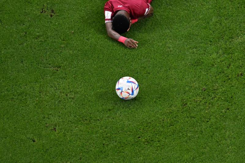 Qatar's Ismaeel Mohammad collapses dejected on the pitch after his side's 3-1 defeat to Senegal. AFP