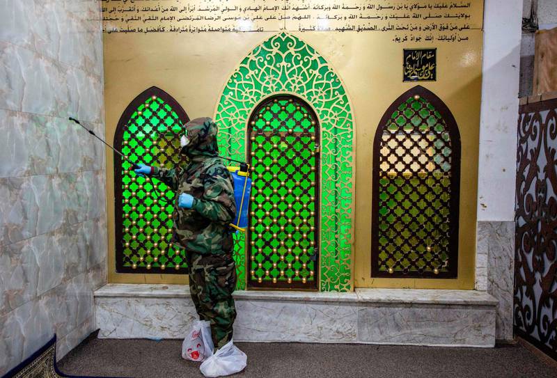 A civil defence worker disinfects a shrine in the Ashar district of Iraq's southern city of Basra.   AFP