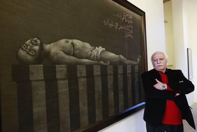 Syrian artist Youssef Abdelke stands near his artwork during an exhibition at a gallery in Beirut on January 6. Abdelke has been touring the Middle East with his work but he always returns, doggedly, to his base in Damascus. Jamal Saidi / Reuters