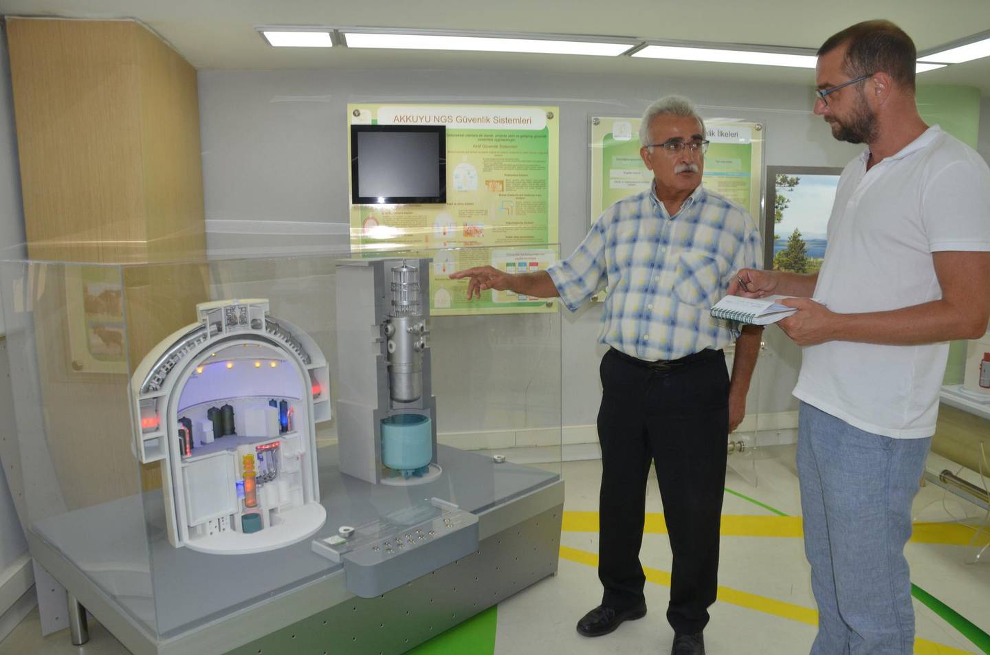 Lutfi Sarici, the manager of Akkuyu's nuclear information centre, shows a model of what the Russian-led project is expected to look like. Necdet Tas for The National