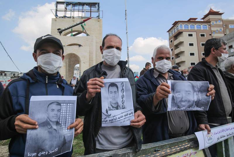 Palestinians, wearing protective masks amid fears of the spread of the novel coronavirus, take part in a protest in solidarity with Palestinian prisoners in Israeli jails outside the UN High Commissioner's offices in Rafah. AFP