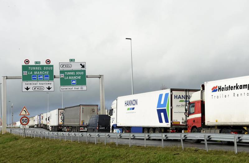 Trucks wait on the A16 motorway to board shuttles at the entrance to the Channel Tunnel site in Calais, northern France, on December 17, 2020.   Unprecedented numbers of heavy goods vehicles are seeking to cross from France to Britain ahead of the British exit from the single market this year, creating huge tailbacks around Calais, French officials said on Thursday / AFP / FRANCOIS LO PRESTI
