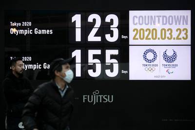 A man walks near a countdown display for the Tokyo 2020 Olympics and Paralympics in Tokyo on Monday. AP