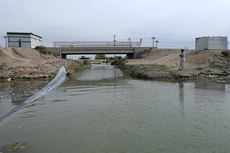 A sewage pipe crosses Iraqi marshland in the southern district of Chibayish. In a country where the state cannot guarantee basic services, 70 percent of Iraq's industrial waste is dumped directly into rivers or the sea, according to the UN and academics. The marshland, reputed to be the site of the Garden of Eden, previously faced destruction at the hands of Saddam Hussein and is now jeopardised by poor wastewater management and climate change. AFP