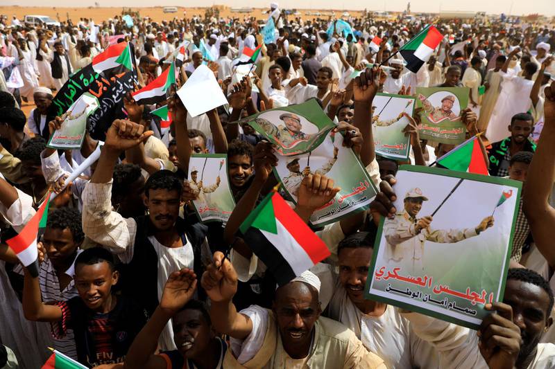 Supporters of Lieutenant General Mohamed Hamdan Dagalo, deputy head of the military council and head of paramilitary Rapid Support Forces (RSF), cheer as he arrives at a meeting in Aprag village, 60km away from Khartoum, Sudan. Reuters