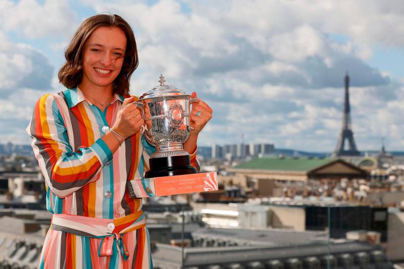 Poland's Iga Swiatek poses with the trophy Suzanne Lenglen near the Eiffel Tower in Paris. AFP