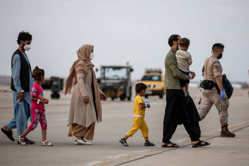 Afghan families disembark from a plane at Torrejon Military Air Base in Madrid, Spain. Getty Images