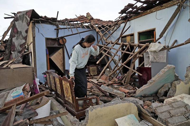A scene of devastation greets this woman, whose house was damaged by the earthquake in Cianjur, Indonesia. AP