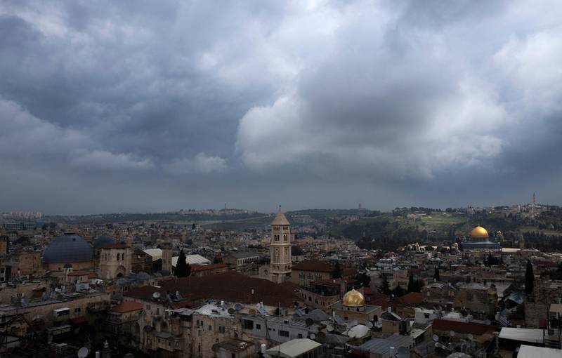 epa07478161 A view of Jerusalem's Old City as the sun hits the Dome of the Rock (R) on The Temple Mount, known in Arabic as Hareem el-Sharif (The Noble Sanctuary), during cloudy day, 01 April 2019. At left are the grey domes of the Church of the Holy Sepulchre where, according to Christian tradition, Jesus Christ was crucified, buried and resurrected during Holy Week.  EPA/JIM HOLLANDER