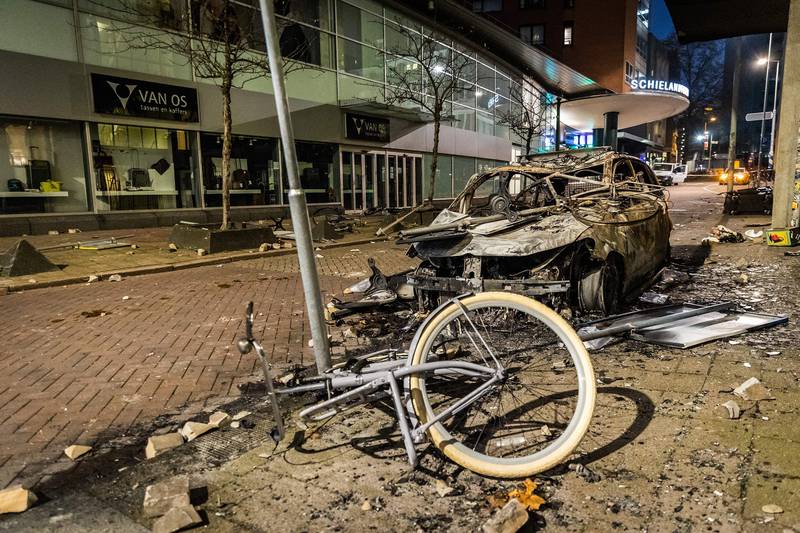 Dutch police fired warning shots, injuring at least two people, after rioters torched a police car. AFP