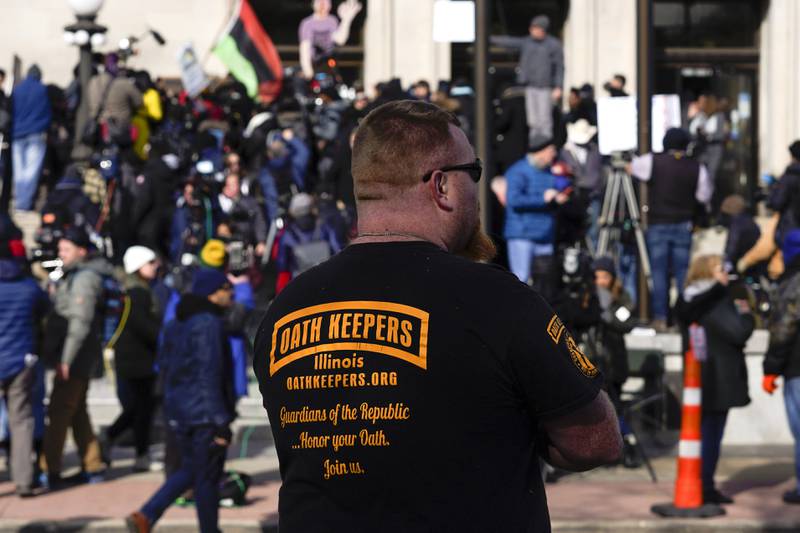 A man wearing an Oath Keepers shirt stands outside the Kenosha County Courthouse in Kenosha, Wisconsin. AP