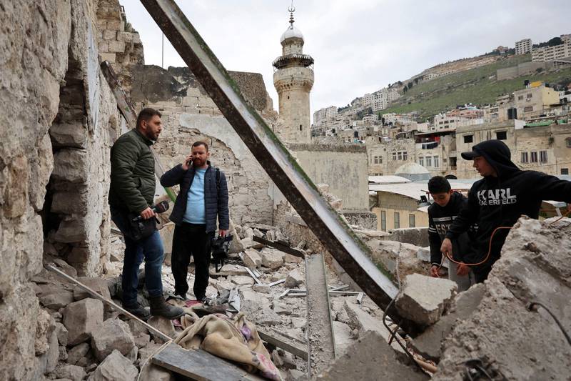 Palestinian men check a house that was demolished during an Israeli army raid in the Old City of Nablus the previous day. AFP