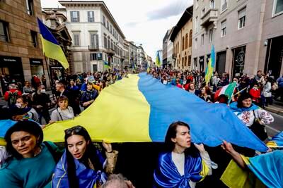 People carry a large Ukrainian flag as they attend a rally to mark the 77th anniversary of Liberation Day in Milan, Italy.  The day remembers Italians who fought against the Nazis and Mussolini's troops during the Second World War. EPA