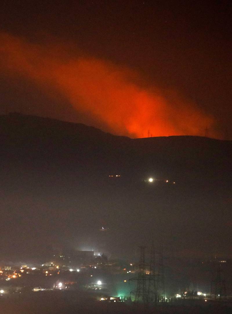 Smoke rises past a mountain as seen from Damascus countryside, Syria December 25, 2018. REUTERS/Omar Sanadiki