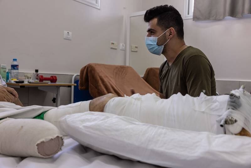 “We now start to determine whether the traumatic events of the war turn into post-traumatic stress or not,” Mahmoud Awad, a psychologist with Médecins Sans Frontières at Al-Awda Hospital in northern Gaza explained. Here, he sits with one of the patients who lost his leg.