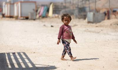 A child who fled Syria's Idlib province walks at a camp in Kafr Lusin near the border with Turkey in the northern part of the province.  Regime and Russian air raids pounded Syria's last major rebel bastion of Idlib today after an overnight lull, killing at least one child, a monitor said.  AFP