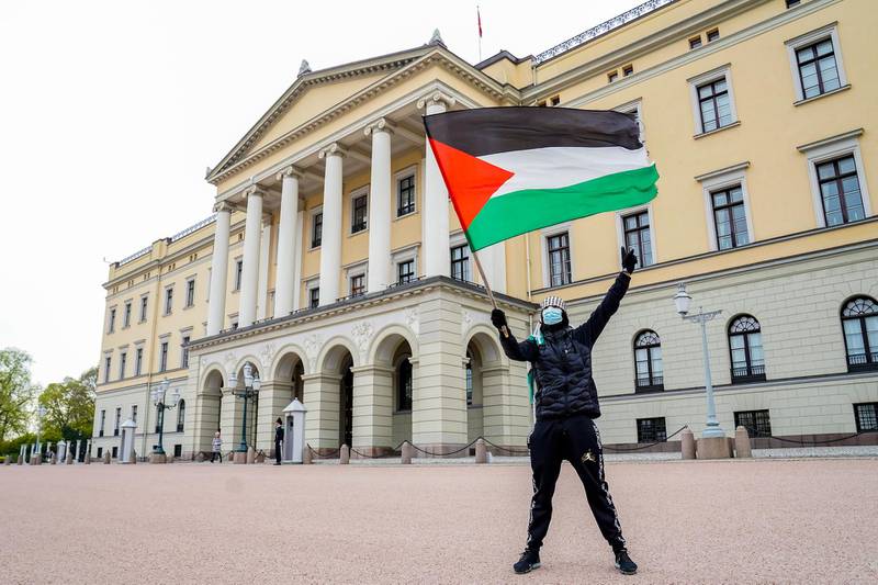 A lone protester waves the Palestine flag during a demonstration in support of Palestine, outside the Israeli embassy, in Oslo, Norway. EPA