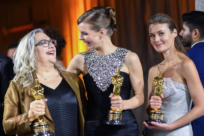 US filmmaker Carol Dysinger and director Elena Andreicheva, winners of the award for Best Short Subject Documentary for "Learning to Skateboard in a Warzone (If You're a Girl)", and Icelandic musician Hildur Gudnadottir (centre) winner of the award for Best Original Score for "Joker", at the Governors Ball after the Oscars on Sunday, February 9, 2020, at the Dolby Theatre in Los Angeles. AFP