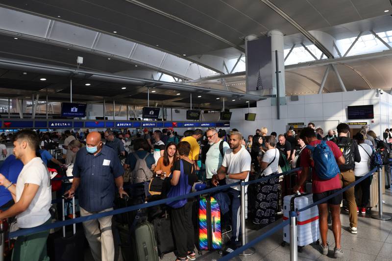 People queue to drop bags at New York's John F Kennedy International Airport. Reuters