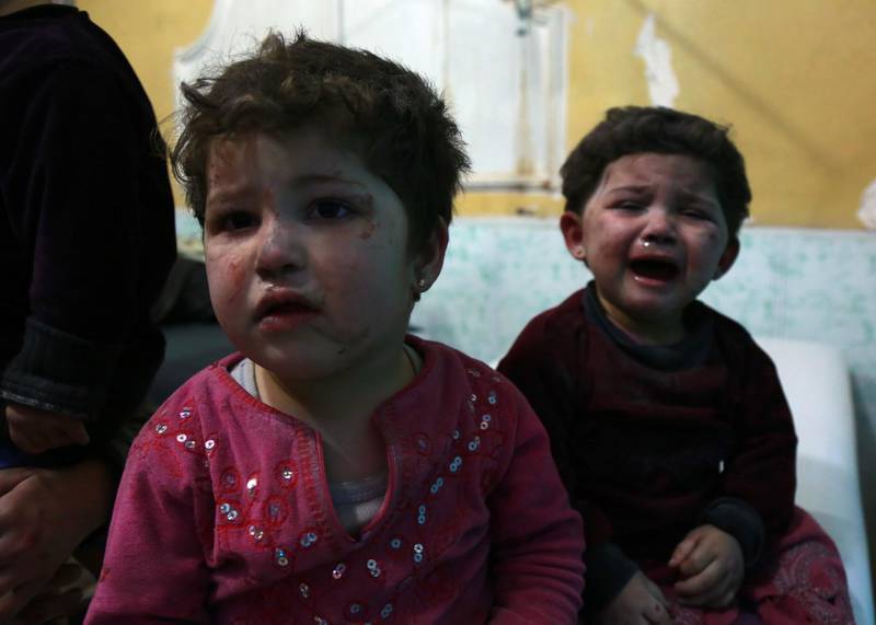 Children cry in a hospital in the rebel-held town of Douma, in the besieged Eastern Ghouta region on the outskirts of the capital Damascus, following reported regime bombardment on the area on February 24, 2018. Hamza Al-Ajweh / AFP