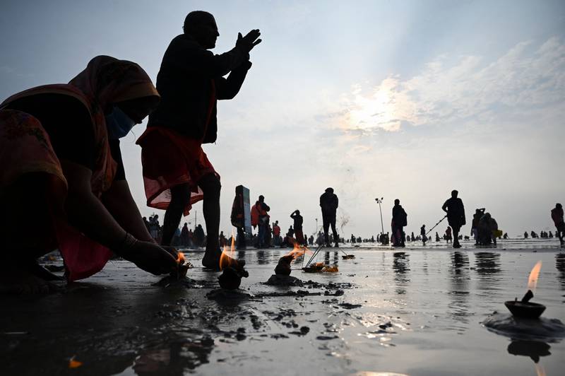 Pilgrims perform rituals at the beach during the Hindu religious festival of Gangasagar Mela on Sagar Island, in West Bengal. AFP