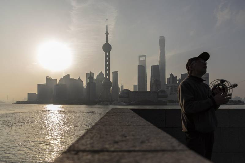 A man flies a kite on the Bund as the Lujiazui Financial District stands in the background in Shanghai, China, on Saturday, April 10, 2021. China's population is aging more quickly than most of the worlds developed economies due to decades of family planning aimed at halting population growth. Photographer: Qilai Shen/Bloomberg