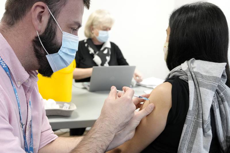 Daniel Zadorozni gives a Pfizer coronavirus vaccine in London on Wednesday. AP