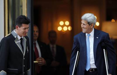 US Secretary of State John Kerry talks to a hotel staff member as he leaves his hotel on the way to mass at the St Stephen's Cathedral in Vienna. World powers raced to clinch a landmark deal to prevent Iran acquiring a nuclear bomb, with diplomats saying an agreement would be announced on Monday. AFP PHOTO 