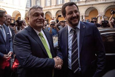 Italy's Interior Minister Matteo Salvini (R) shakes hands with Hungary's Prime Minister Viktor Orban ahead of a meeting in Milan on August 28, 2018. (Photo by MARCO BERTORELLO / AFP)