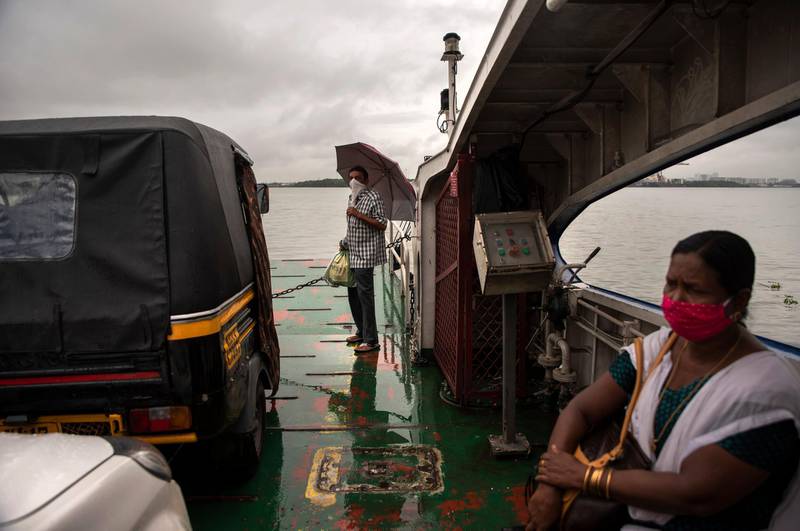 Commuters travel in a ferry during rain in Kochi, Kerala state. AP