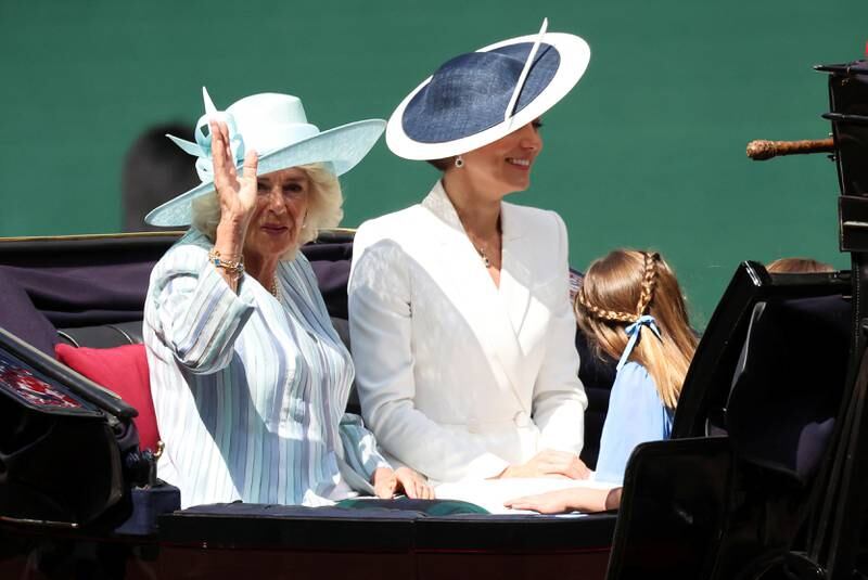Left; Camilla, Duchess of Cornwall, who wore a blue striped dress coat and wide-brimmed blue hat. Right; Kate, Duchess of Cambridge. Reuters 